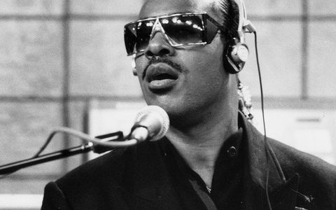 Stevie Wonder at a microphone